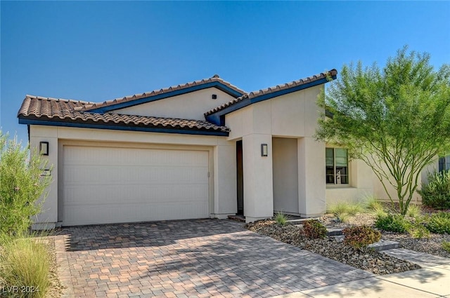 mediterranean / spanish-style home featuring a garage