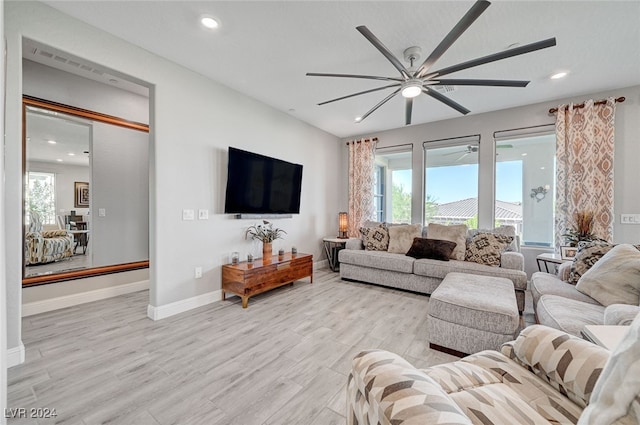 living room featuring ceiling fan and light wood-type flooring