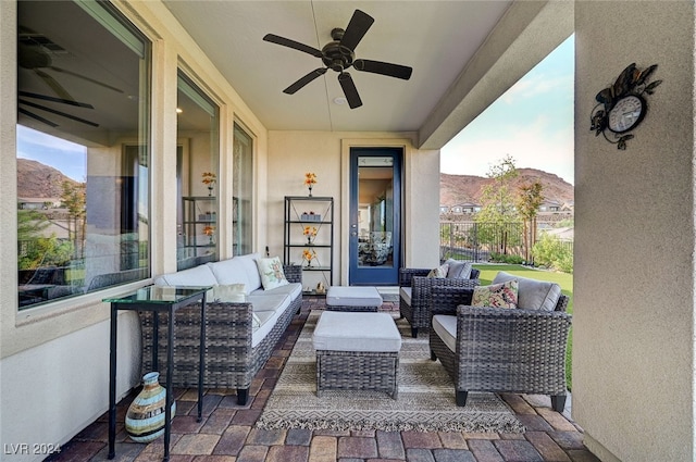 view of patio / terrace featuring a mountain view, an outdoor hangout area, and ceiling fan