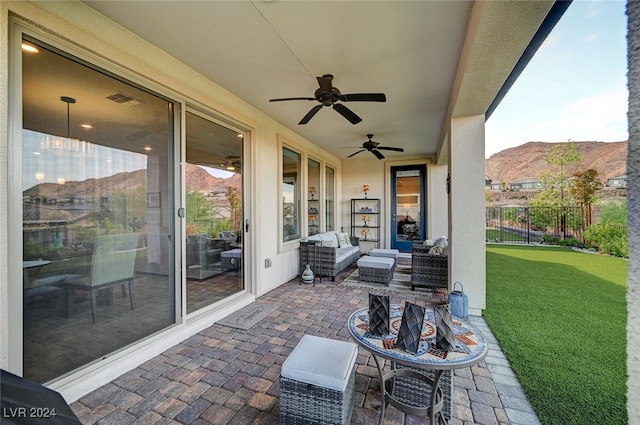 view of patio / terrace with a mountain view, an outdoor hangout area, and ceiling fan