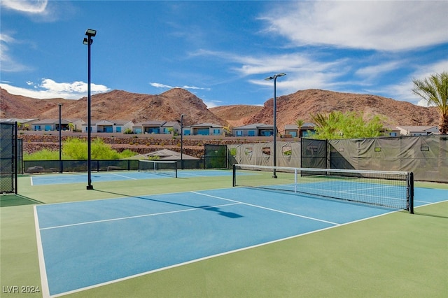 view of tennis court featuring a mountain view