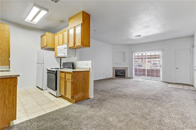 kitchen featuring light carpet, a fireplace, and white appliances