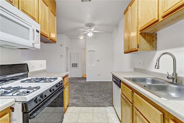 kitchen with light brown cabinets, sink, light colored carpet, white appliances, and ceiling fan