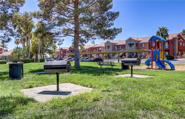 surrounding community with a lawn and a playground