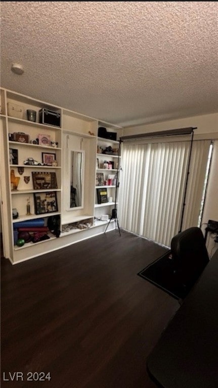 living room with hardwood / wood-style floors and a textured ceiling