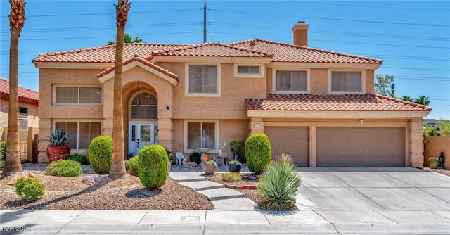 mediterranean / spanish-style house with a garage