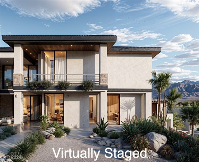 view of front facade featuring a balcony and a mountain view