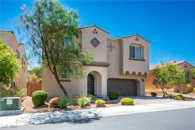 mediterranean / spanish-style home with a garage