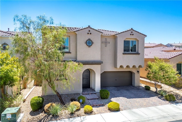 mediterranean / spanish-style house featuring a garage