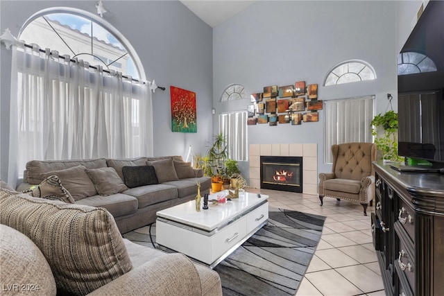 tiled living room with high vaulted ceiling and a tile fireplace