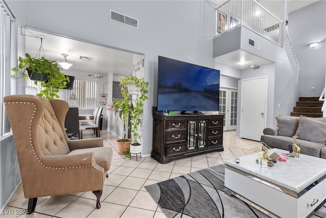 living room featuring a high ceiling and light tile patterned floors