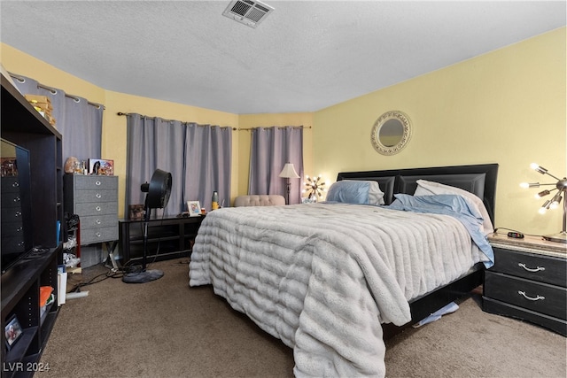 carpeted bedroom featuring a textured ceiling