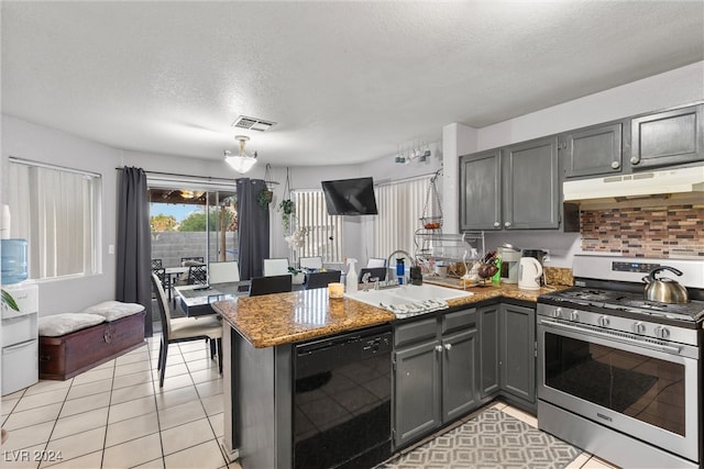 kitchen with stainless steel gas range, kitchen peninsula, sink, black dishwasher, and gray cabinetry