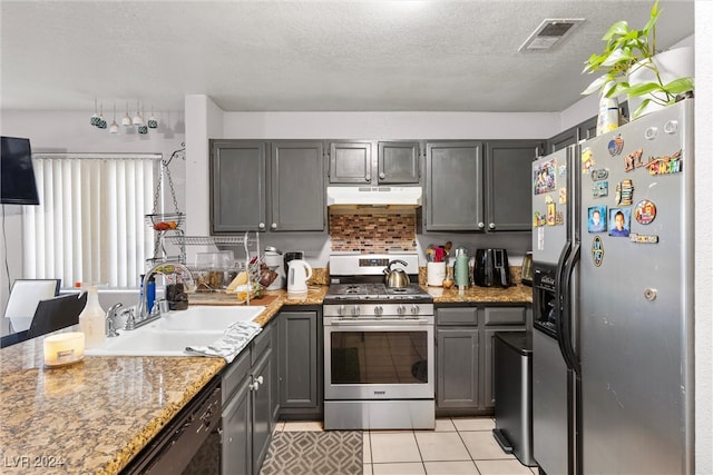 kitchen featuring gray cabinets, appliances with stainless steel finishes, sink, and light tile patterned flooring