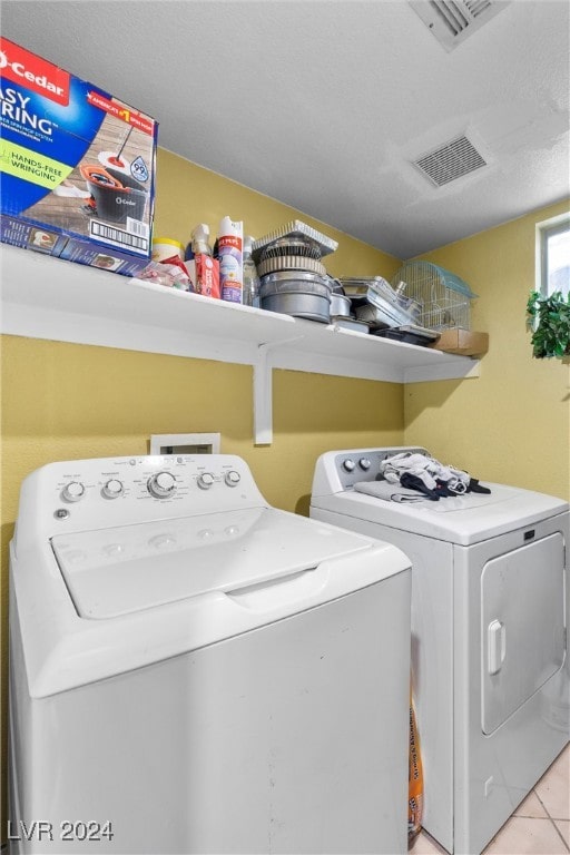 washroom featuring independent washer and dryer and light tile patterned flooring