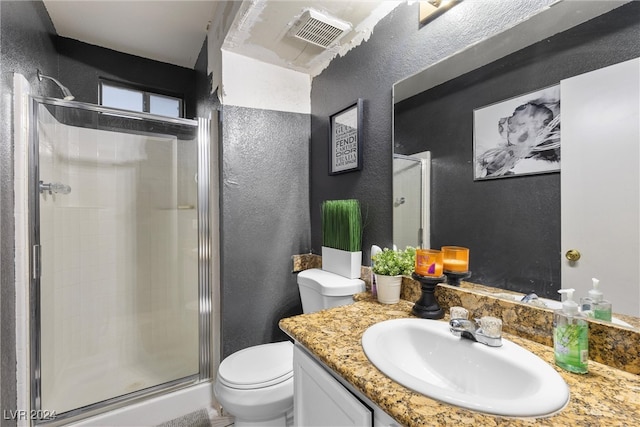 bathroom featuring an enclosed shower, toilet, and vanity