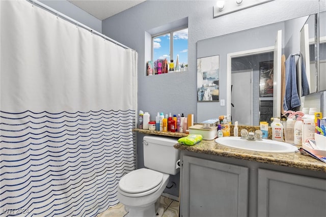 bathroom featuring vanity, toilet, a shower with curtain, and tile patterned floors