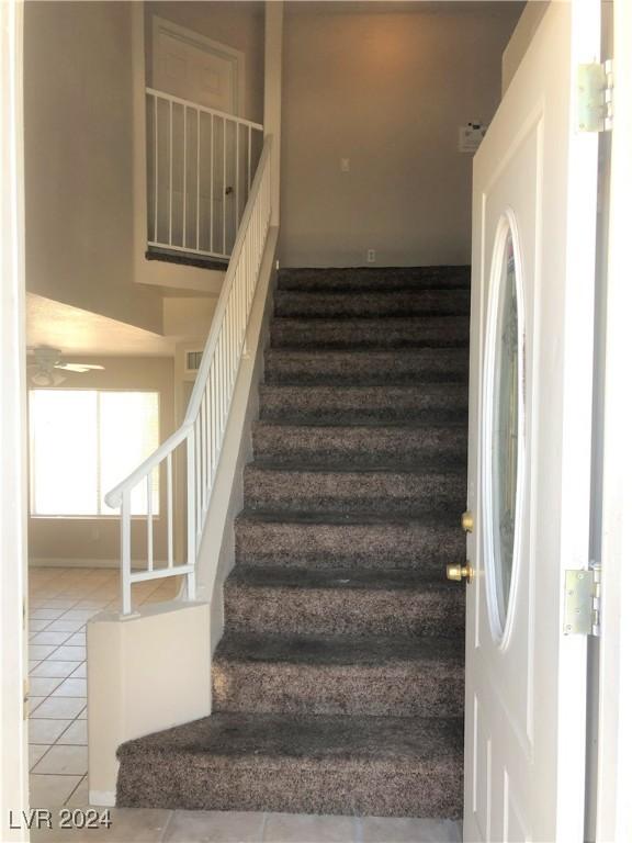 stairs featuring tile patterned flooring