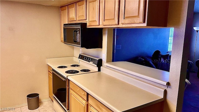 kitchen with light tile patterned floors and electric range