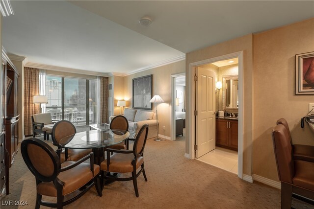 dining area featuring light colored carpet and crown molding