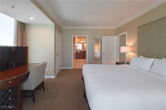 carpeted bedroom with ensuite bath and crown molding