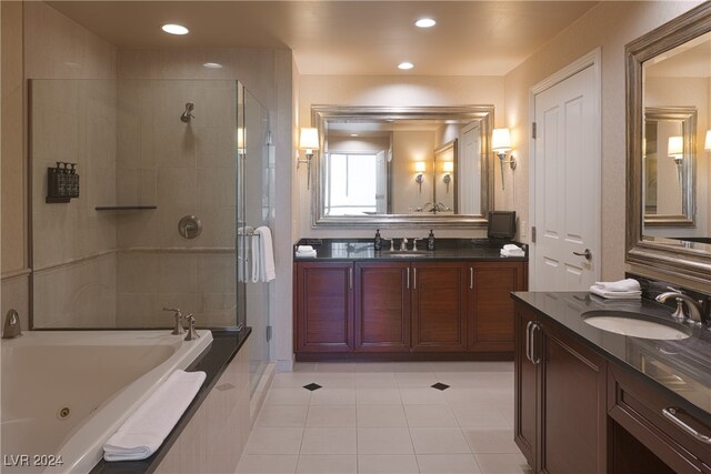 bathroom with tile patterned floors, vanity, and separate shower and tub