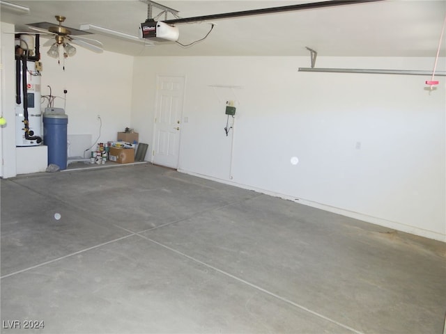 garage with ceiling fan, a garage door opener, and secured water heater