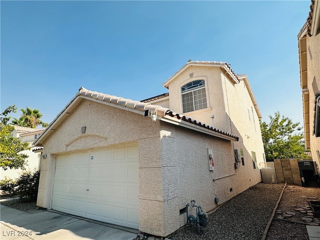 view of side of home featuring a garage