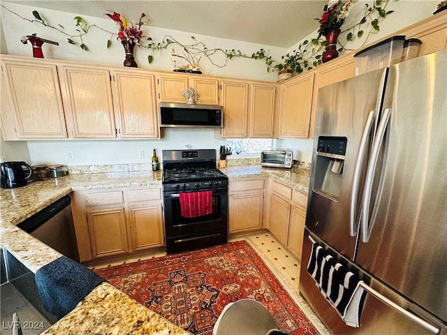 kitchen with light tile patterned floors, appliances with stainless steel finishes, light stone countertops, and light brown cabinetry