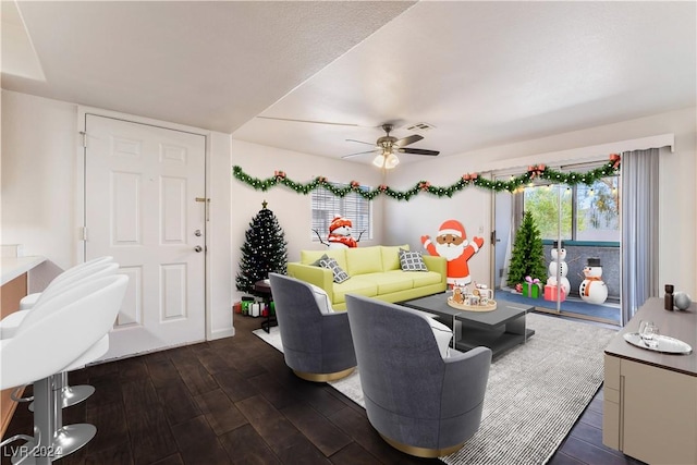 living room with dark hardwood / wood-style floors and ceiling fan