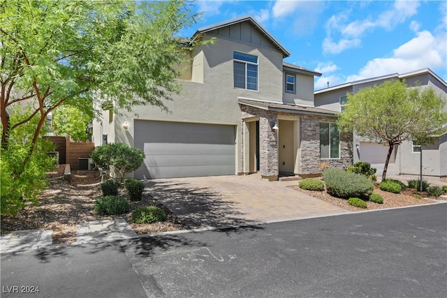 view of front of property with central AC and a garage