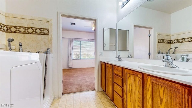 bathroom featuring vanity and washer / clothes dryer