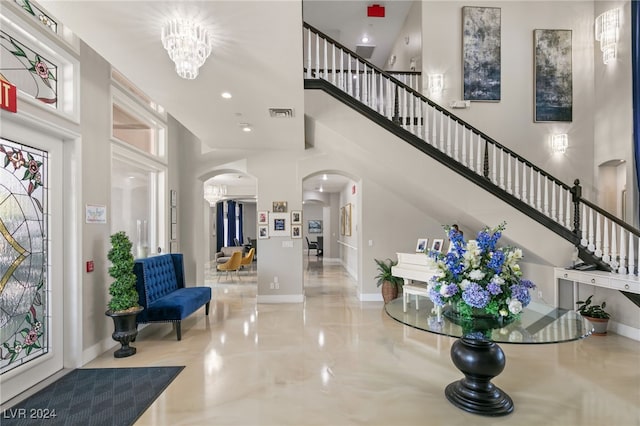 foyer entrance with a high ceiling and an inviting chandelier