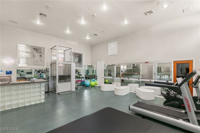 workout room featuring a high ceiling