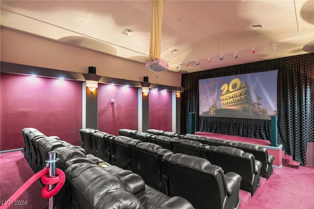 carpeted home theater with vaulted ceiling