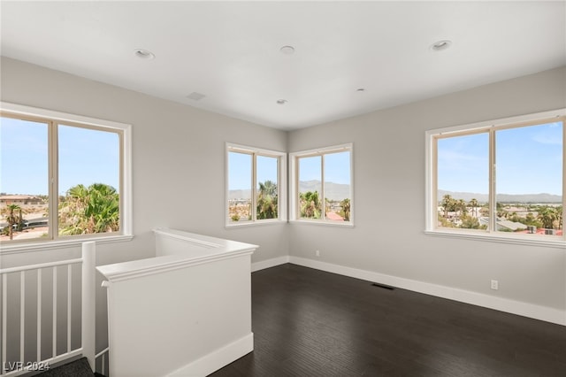 empty room featuring dark hardwood / wood-style flooring