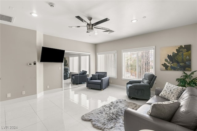 tiled living room featuring ceiling fan