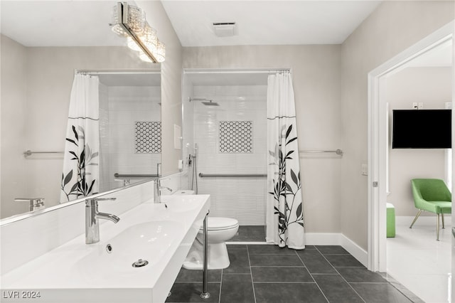 bathroom with tile patterned floors, double sink vanity, and toilet