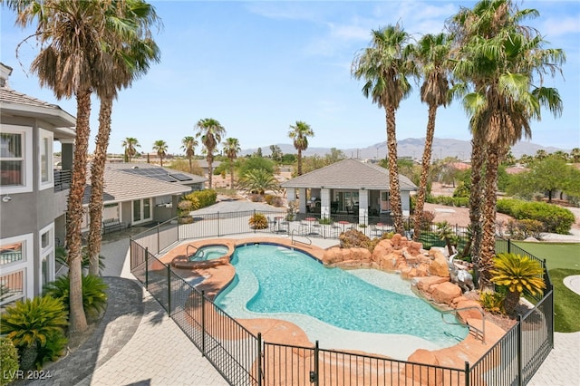 view of pool with an in ground hot tub and a patio