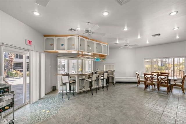 tiled dining area featuring ceiling fan