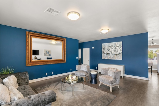 living room featuring ceiling fan and hardwood / wood-style flooring