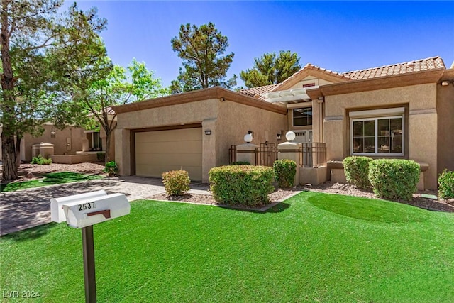 view of front of property featuring stucco siding, an attached garage, a tile roof, and a front lawn