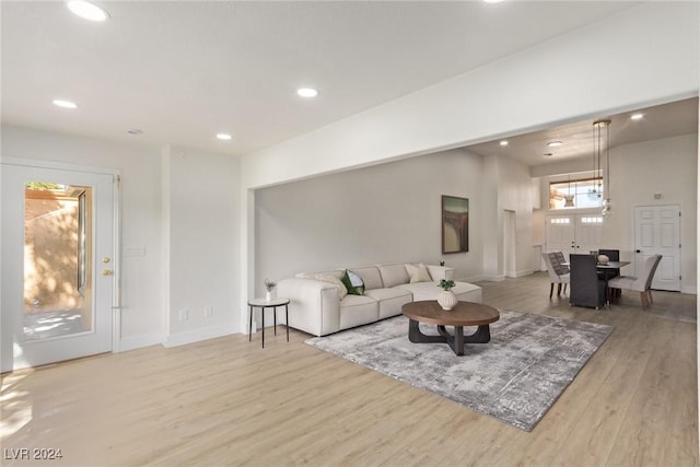 living area with recessed lighting, wood finished floors, and baseboards