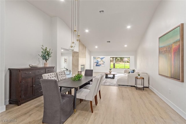 dining room with light wood-type flooring, visible vents, high vaulted ceiling, recessed lighting, and baseboards