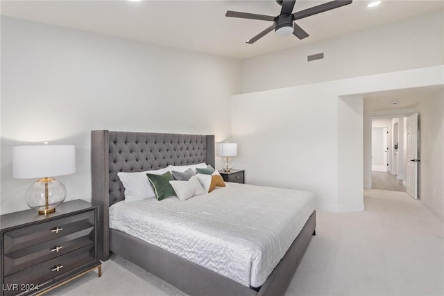 bedroom with ceiling fan, visible vents, and light carpet