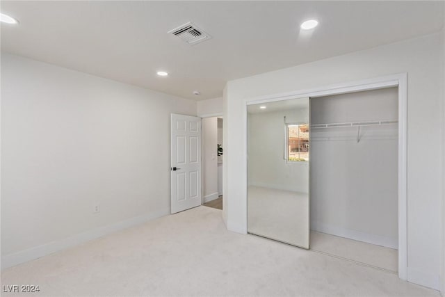 unfurnished bedroom featuring visible vents, recessed lighting, a closet, carpet flooring, and baseboards