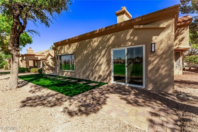 back of house featuring a patio area and stucco siding