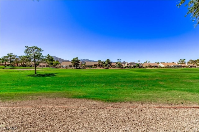 view of community featuring a mountain view, a yard, and a residential view