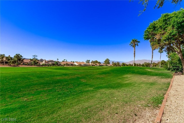 surrounding community featuring a yard and a mountain view