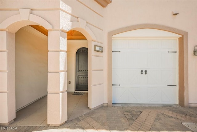 doorway to property with a garage